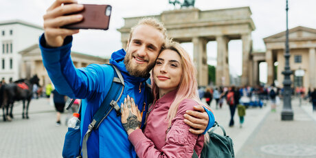 Stylish Young Couple Take A Selfie In Front Of Local Architecture