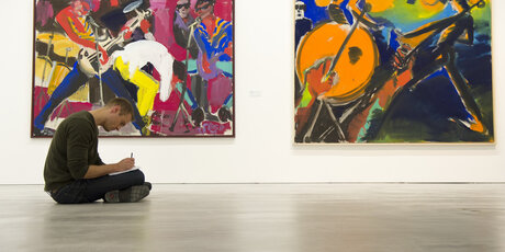 Besucher der Berlinischen Galerie sitzt auf dem Boden und zeichnet