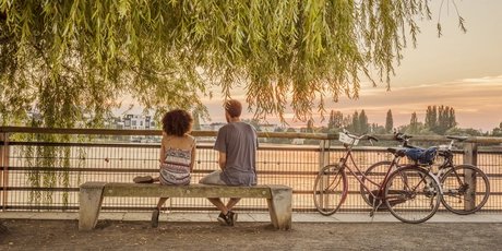 Lake Rummelsburg promenade Romantic break of two cyclists at Lake Rummelsburg in Berlin