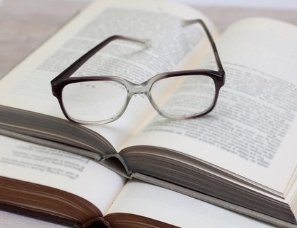 Glasses and open book on a table Glasses and open book on a table