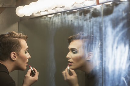 Drag queen makes up in front of the mirror in Berlin