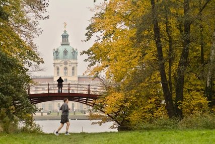 Joggers in the park of Charlottenburg Palace Joggers in the park of Charlottenburg Palace