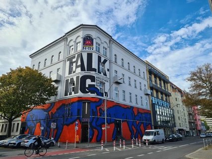 Street Art on the Wall of the Urban Nation Museum. Street Art on the Wall of the Urban Nation Museum: Man is Man's Wolf by Broken Fingaz Crew