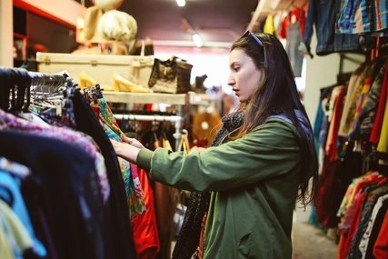 A girl is shopping vintage and second hand clothes A girl is shopping vintage and second hand clothes