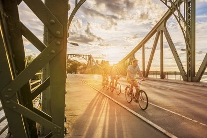 Cyclists on the Glienicke Bridge at sunset Cyclists on the Glienicke Bridge at sunset