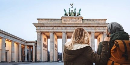 Couple at Brandenburg Gate  Young couple sightseeing at Brandenburg Gate in winter