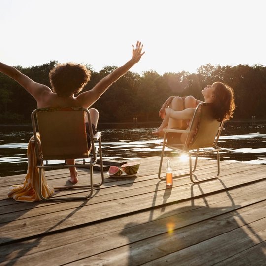 Germany, Berlin, Young couple relaxing on chairs