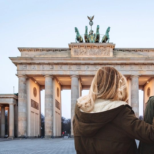 Couple at Brandenburg Gate  Young couple sightseeing at Brandenburg Gate in winter