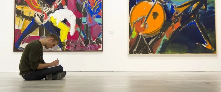 Exhibition "Rainer Fetting" Berlinische Galerie A visitor to the Berlinische Galerie sits on the floor and draws