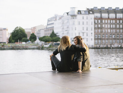 rear view of loving women couple in Berlin, embracing