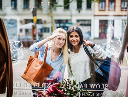 Two women looking through a shop window in Berlin 