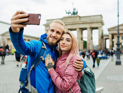 Stylish Young Couple Take A Selfie In Front Of Local Architecture