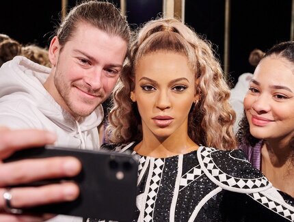 Visitors with wax figure Beyonce at Madame Tussauds Berlin