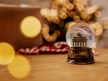 Atmospheric Christmas decoration with a snow globe of the Brandenburg Gate