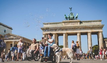 Barrierefrei: Frau im Rollstuhl vor dem Brandenburger Tor