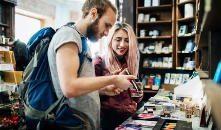 Two Young Backpackers Exploring A Store Together