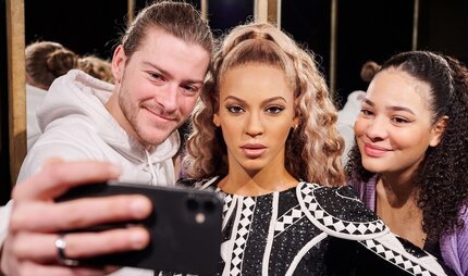 Visitors with wax figure Beyonce at Madame Tussauds Berlin