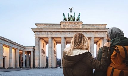 Couple at Brandenburg Gate  Young couple sightseeing at Brandenburg Gate in winter