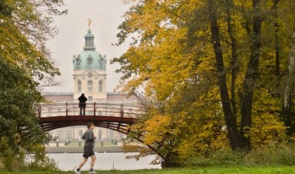 Joggers in the park of Charlottenburg Palace Joggers in the park of Charlottenburg Palace