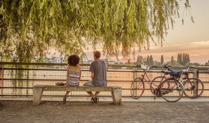 Lake Rummelsburg promenade Romantic break of two cyclists at Lake Rummelsburg in Berlin