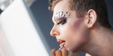 Drag queen doing make up Drag queen doing make up in front of a mirror