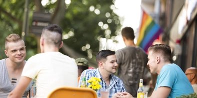 Café in Schöneberg There's always something going on in Berlin for LGBTI: Gay couple on the road in Berlin-Schöneberg