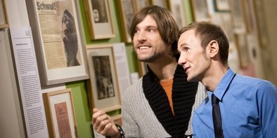 Two men in the gay museum  Two men look at pictures in the Gay Museum Berlin